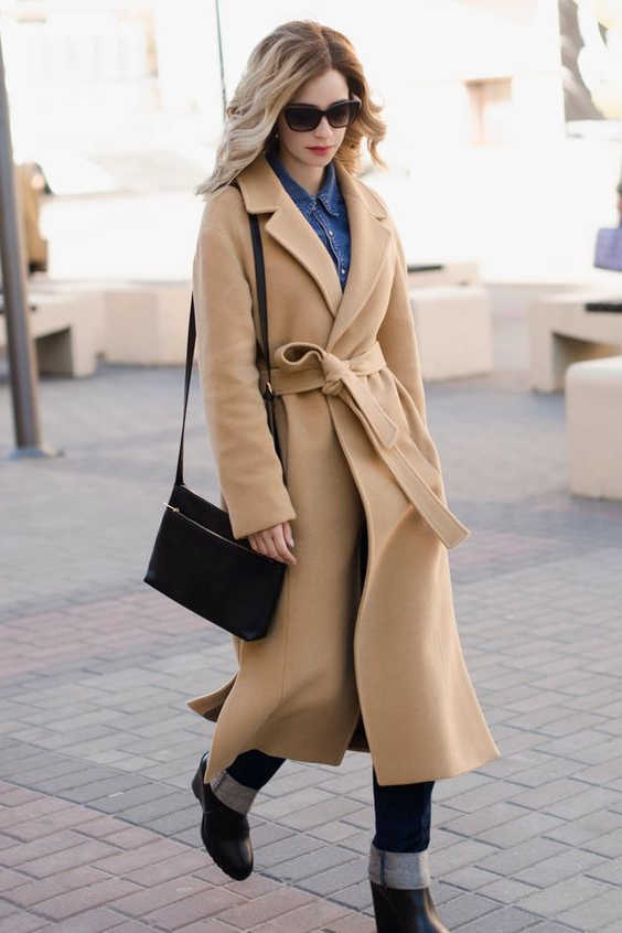 belted camel coat with cuffed jeans and boots